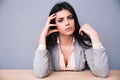 Serious young woman sitting at the table Royalty Free Stock Photo