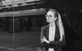 Serious young woman in suit and glasses, black and white Royalty Free Stock Photo