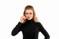 Serious young woman zipping her mouth shut, show taboo hush gesture and frowning, be quiet. Keeping quiet concept Royalty Free Stock Photo