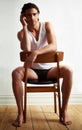 Seriously sexy. Portrait of a handsome young man sitting on a chair. Royalty Free Stock Photo