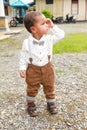 Seriously thinking adorable toddler boy in shirt with bowtie