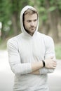seriousness and masculinity. sportswear fashion. sportsman relax after training outdoor. handsome unshaven man in hood