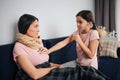 Serius small girl listen to her mom`s breathing through stethoscope. She look at her and touch chest. Young woman look Royalty Free Stock Photo