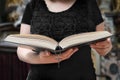 Sermon or homily in church. Woman is reading Bible