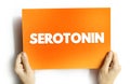 Serotonin is a chemical that carries messages between nerve cells in the brain and throughout your body, text concept on card