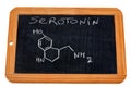 Serotonin chemical formula written on a school slate