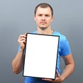 Serous looking man holding empty board - Perfect for raising awareness of something