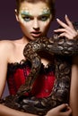 Serpent. Fantasy. Fancy Woman holding Tamed Snake in Hands Royalty Free Stock Photo