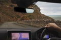 Serpentine mountain road along the ocean coast, photograph from inside a moving car. Soft focus Royalty Free Stock Photo