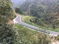 The serpentine mountain road winds up, passing through lush mountains and dense bamboo forests