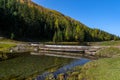 Serpentine river among the mountain peaks. Mountain lake reflects the autumn landscape of the forest with yellow leaves Royalty Free Stock Photo