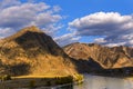 Serpentine river among the mountain peaks. Mountain lake reflects the autumn landscape of the forest with yellow leaves Royalty Free Stock Photo