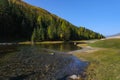 Serpentine river among the mountain peaks. Mountain lake reflects the autumn landscape of the forest with yellow leaves Royalty Free Stock Photo