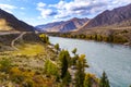 Serpentine river among the mountain peaks. Mountain lake reflects the autumn landscape of the forest with yellow leaves Royalty Free Stock Photo