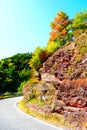 serpentine road curve at a limestone cliff with autumn trees on top Royalty Free Stock Photo