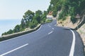 Serpentine road goes up in mountains to Mediterranean Sea in a sunny day on Mallorca island. Road travel and adventure Royalty Free Stock Photo