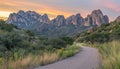 Serpentine sunset road winding through majestic mountain peaks at dusk with captivating scene