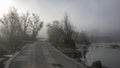 Serpis river at sunrise very calm and foggy and a road to Alcocer de Planes Royalty Free Stock Photo