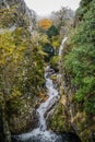 Serra da Estrela Natural Park PORTUGAL - 17 November 2019 - Couple on small bridge in PoÃÂ§o do Inferno waterfall, landscape in fog