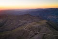 Serra da Freita drone aerial view in Arouca Geopark road with wind turbines at sunset, in Portugal