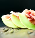 Serrano ham with melon on old wooden table three Royalty Free Stock Photo