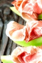 Serrano ham with melon on old wooden table top view Royalty Free Stock Photo