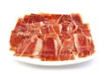 Serrano ham slices on a white dish. Jabugo Royalty Free Stock Photo