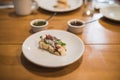 Serrano ham tapa, accompanied by oil and chili sauce and chimichurri on a wooden table Royalty Free Stock Photo