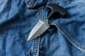 Serrated knife on jeanse background.. Close up. Royalty Free Stock Photo