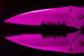 Serrations of a knife reflected in a shiny black surface