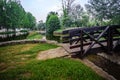 Intentional blurred grass in lowlight next to small wooden bridge and SertÃ£ stream in city park at dusk, PORTUGAL