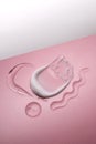 Serum and cream on a pink background. Textures. Royalty Free Stock Photo