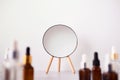 Serum or Liquid Collagen Bottles and mirror on marble table. Anti age beauty Cosmetics products concept, selective focus