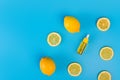 Serum in a transparent bottle with a pipette with yellow sliced lemons on blue background Royalty Free Stock Photo