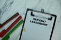 Servant Leadership write on paperwork isolated on Wooden Table