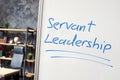 Servant leadership written on the whiteboard in the office.
