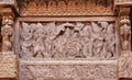 Servants and admirers of the Indian god on carved wooden wall of traditional Hindu temple.