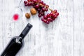 Serve wine. Bottle, glass, nuts and grape on wooden table background top view copyspace