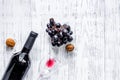 Serve wine. Bottle, glass, nuts and grape on wooden table background top view copyspace