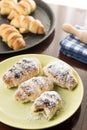 Served baked bun rolls with coconut on the plate with blurred background Royalty Free Stock Photo