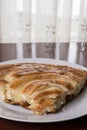 Served balkan burek cheese pie on the plate with backlight behind Royalty Free Stock Photo