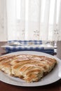 Served balkan burek cheese pie on the plate with silverware on the plate in the background Royalty Free Stock Photo