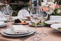 Served for banquet restaurant table with dishes, snack, cutlery, wine and water glasses, european food, selective focus Royalty Free Stock Photo