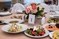 Served for banquet restaurant table with dishes, snack, cutlery, wine and water glasses, european food, selective focus Royalty Free Stock Photo