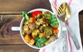 Served beef meat stewed with vegetables in ceramic pot on wooden background Royalty Free Stock Photo