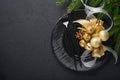 Served christmas table setting empty black ceramic plate on dark background Christmas Decoration. Holiday Decorations with gold Royalty Free Stock Photo