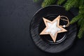 Served christmas table setting empty black ceramic plate on dark background. Christmas Decoration. Holiday Decorations with wooden Royalty Free Stock Photo