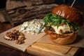 Served craft beef burger with arugula, fresh walnuts and blue cheese laying next to it. Restaurant concept. Street food Royalty Free Stock Photo