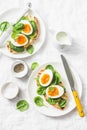 Served Easter brunch plate - grilled bread sandwich with spinach and boiled eggs on white background