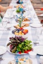 served festive table with snacks. holiday in open air. salad, fruits and cheeses Royalty Free Stock Photo